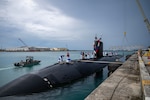 Sailors assigned to the Los Angeles-class fast-attack submarine USS Annapolis (SSN 760) conduct mooring operations at Naval Base Guam, Oct. 4, 2024. Annapolis returns to its homeport after completing a 3-month western Pacific deployment. Assigned to Commander, Submarine Squadron 15 at Polaris Point, Naval Base Guam, Annapolis is one of four Los Angeles-class fast-attack submarines forward-deployed in the Pacific. Renowned for their unparalleled speed, endurance, stealth, and mobility, the Los Angeles-class submarine serves as the backbone of the Navy's submarine force, ensuring readiness and agility in safeguarding maritime interests around the world. (U.S. Navy photo by Mass Communication Specialist 1st Class Justin Wolpert)