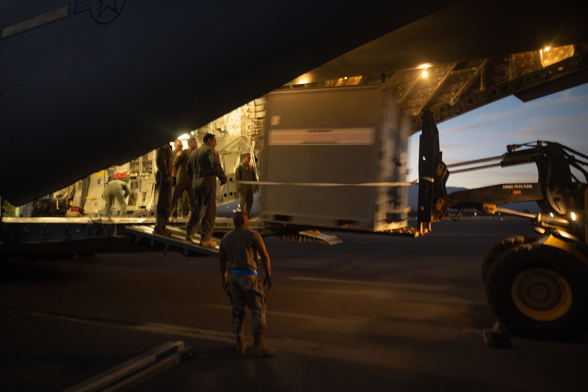 U.S. Air Force Airmen assigned to the 15th Wing and 154th Wing utilize a forklift to unload cargo from a C-17 Globemaster III during Joint Pacific Multinational Readiness Center at the Kahului Airport on Maui, Hawaii, Oct. 5, 2024. The Joint Pacific Multinational Readiness Center (JPMRC) is the Army’s newest Combat Training Center (CTC) and generates readiness in the environments and conditions where our forces are most likely to operate in. JPMRC 25-01 highlights our commitment to partnership and a free and open Indo-Pacific and includes training participants from across the U.S. Joint Force and multinational Allies and partners. (U.S. Air Force photo by Senior Airman Mark Sulaica)