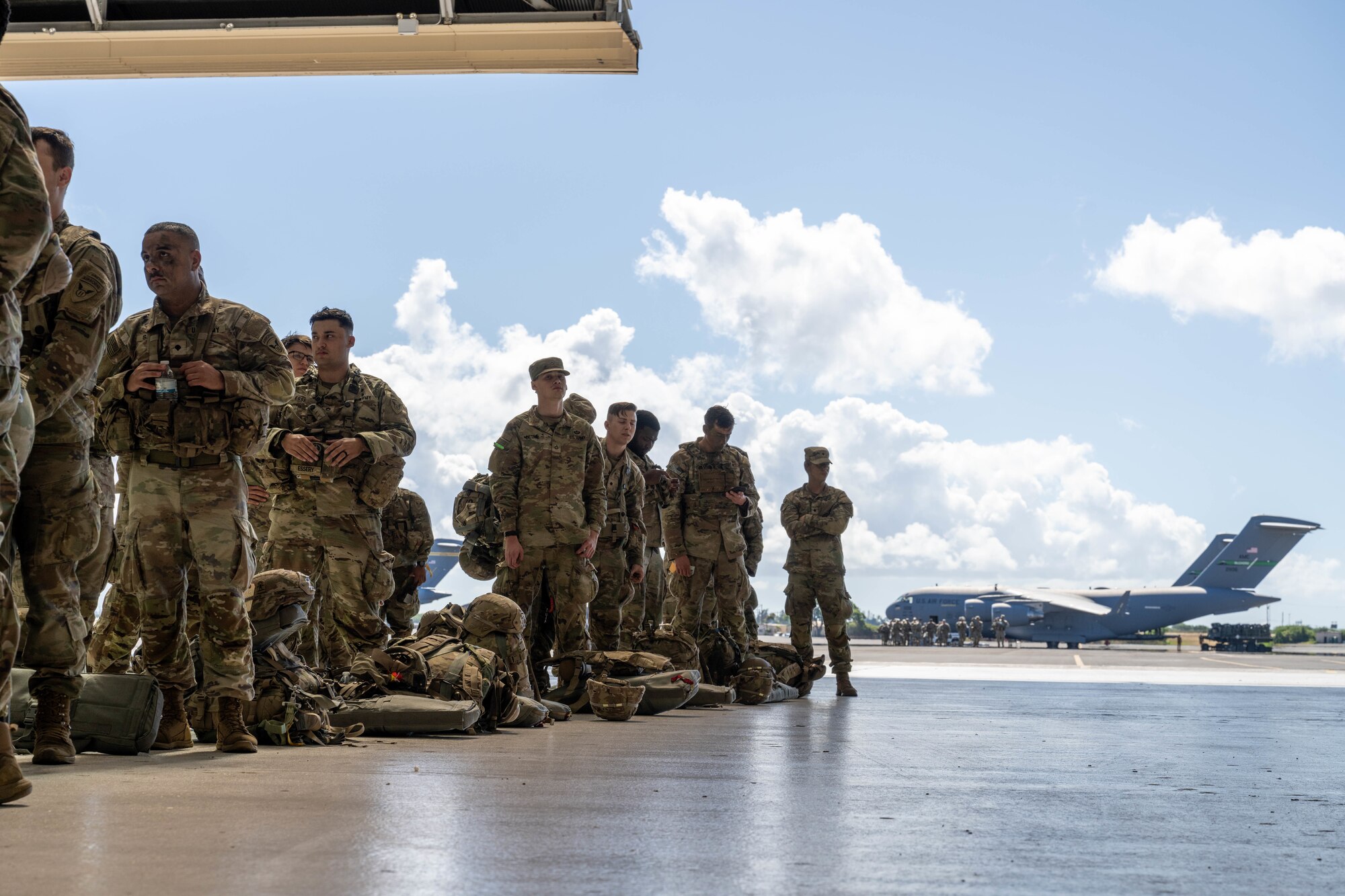 U.S. Army Soldiers from the 11th Airborne Division wait in line to in-process at Joint Base Pearl Harbor-Hickam, Hawaii, Oct. 7, 2024 during Joint Pacific Multinational Readiness Center 25-01. The Joint Pacific Multinational Readiness Center (JPMRC) is the Army’s newest Combat Training Center (CTC) and generates readiness in the environments and conditions where our forces are most likely to operate in. JPMRC 25-01 includes training participants from across the U.S. Joint Force, and multinational Allies and partners. (U.S. Air Force photo by Airman 1st Class Aden Brown)
