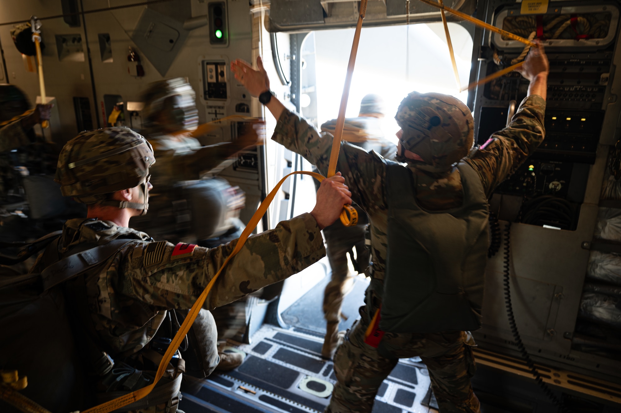 Royal Australian Air Force Corporal Felicity Hull, Number 36 Squadron loadmaster, pulls the static line parachute bags back into a C-17 Globemaster III during Joint Pacific Multinational Readiness Center 25-01 while flying over Hilo, Hawaii, Oct. 7, 2024. The Joint Pacific Multinational Readiness Center (JPMRC) is the Army’s newest Combat Training Center (CTC) and generates readiness in the environments and conditions where our forces are most likely to operate in. JPMRC 25-01 highlights our commitment to partnership and a free and open Indo-Pacific and includes training participants from across the U.S. Joint Force and multinational Allies and partners. (U.S. Air Force photo by Senior Airman Mark Sulaica)