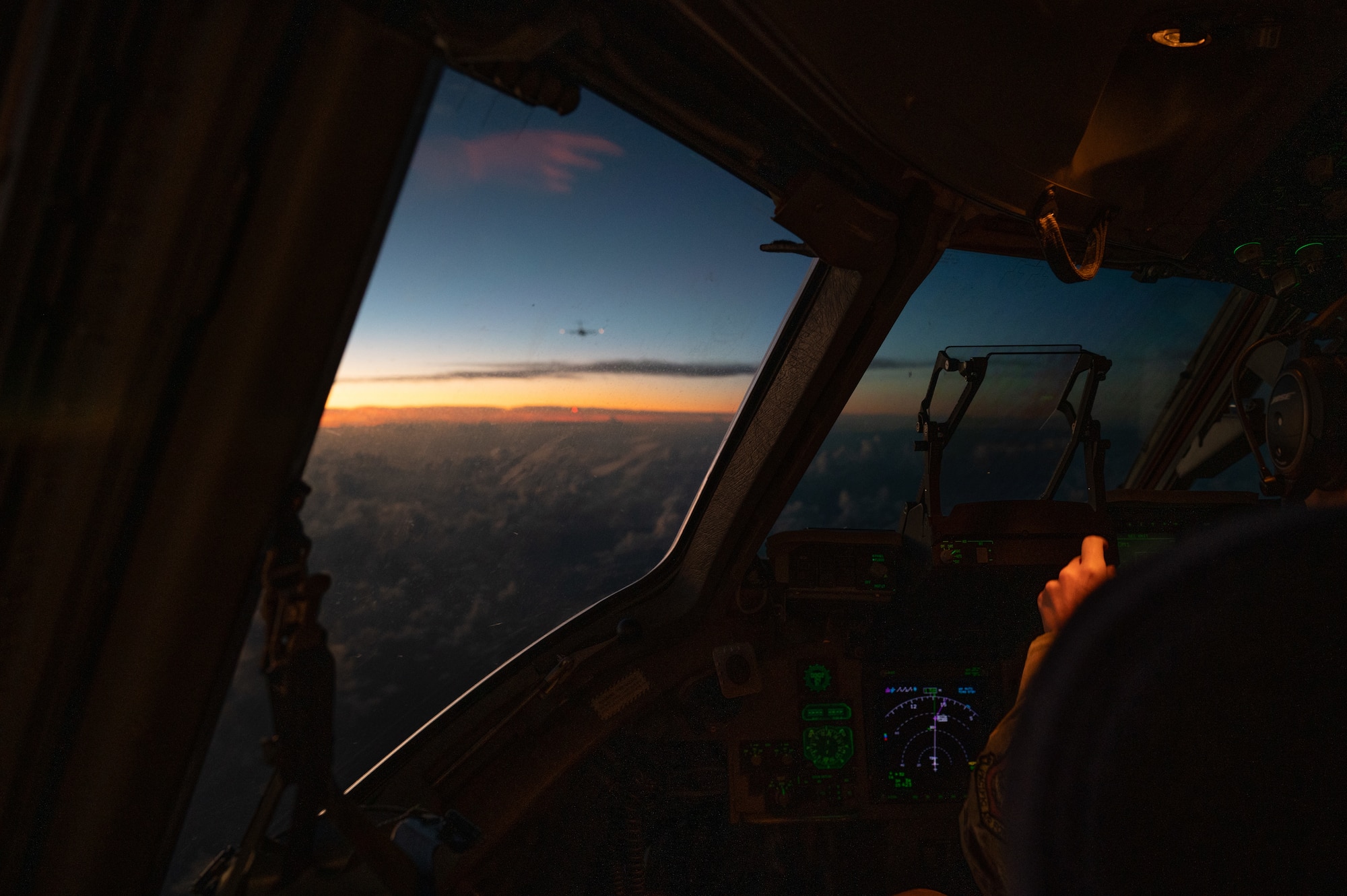 U.S. Air Force Capt. Carol Champion, 535th Airlift Squadron pilot, flies in a formation with several other C-17 Globemaster IIIs during Joint Pacific Multinational Readiness Center 25-01 over the Pacific Ocean, Oct. 7, 2024. The Joint Pacific Multinational Readiness Center (JPMRC) is the Army’s newest Combat Training Center (CTC) and generates readiness in the environments and conditions where our forces are most likely to operate in. JPMRC 25-01 highlights our commitment to partnership and a free and open Indo-Pacific and includes training participants from across the U.S. Joint Force and multinational Allies and partners. (U.S. Air Force photo by Senior Airman Mark Sulaica)