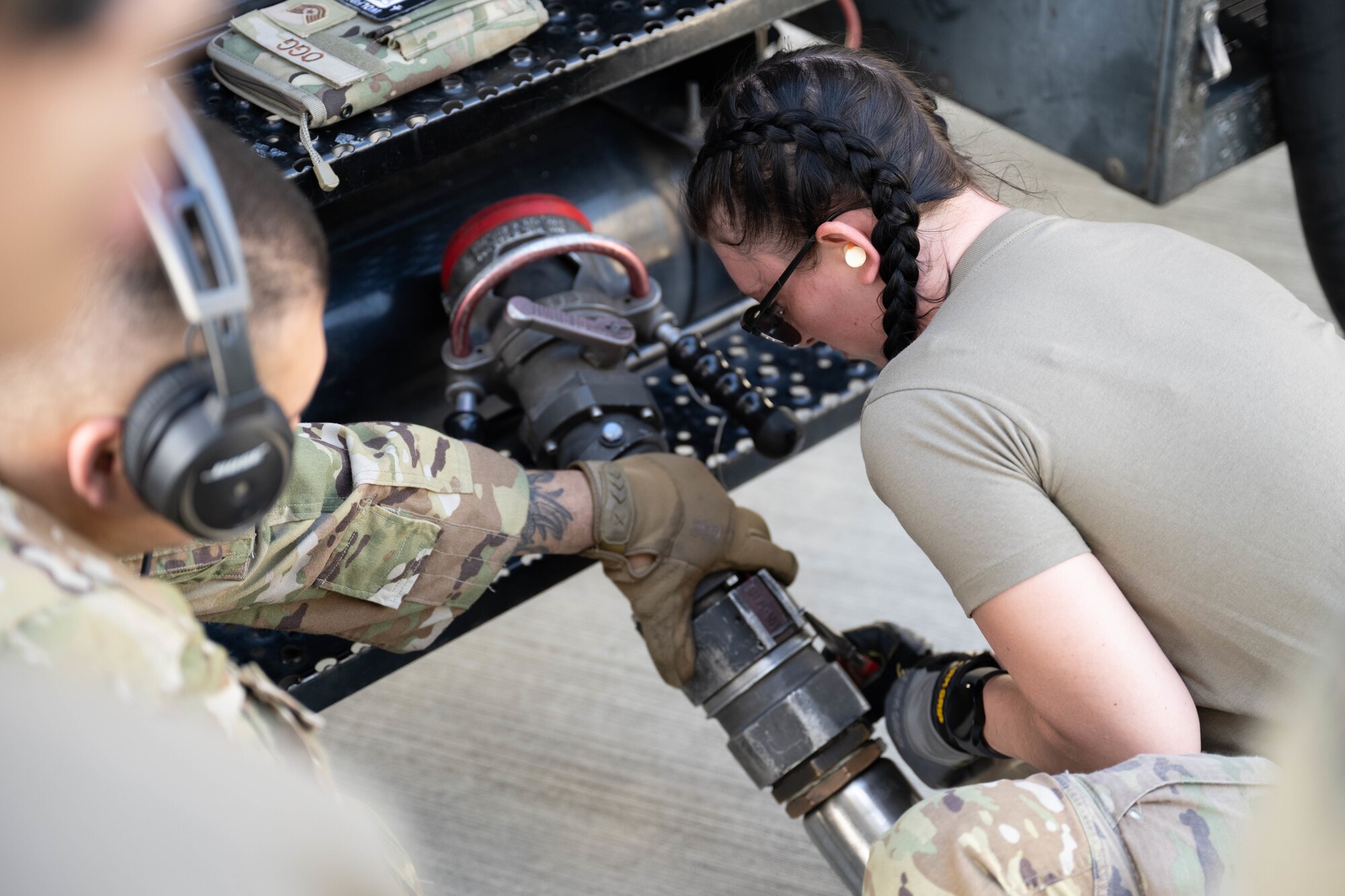 U.S. Air Force Airmen with the 7th Airlift Squadron transfer fuel using the R-11 Refueler on the flightline of Marine Corps Base Hawaii during exercise Joint Pacific Multinational Readiness Center 25-01, Oct. 9, 2024. The Joint Pacific Multinational Readiness Center (JPMRC) is the Army’s newest Combat Training Center (CTC) and generates readiness in the environments and conditions where our forces are most likely to operate in. JPMRC 25-01 includes training participants from across the U.S. Joint Force, and multinational Allies and partners. (U.S. Air Force photo by Airman 1st Class Aden Brown)