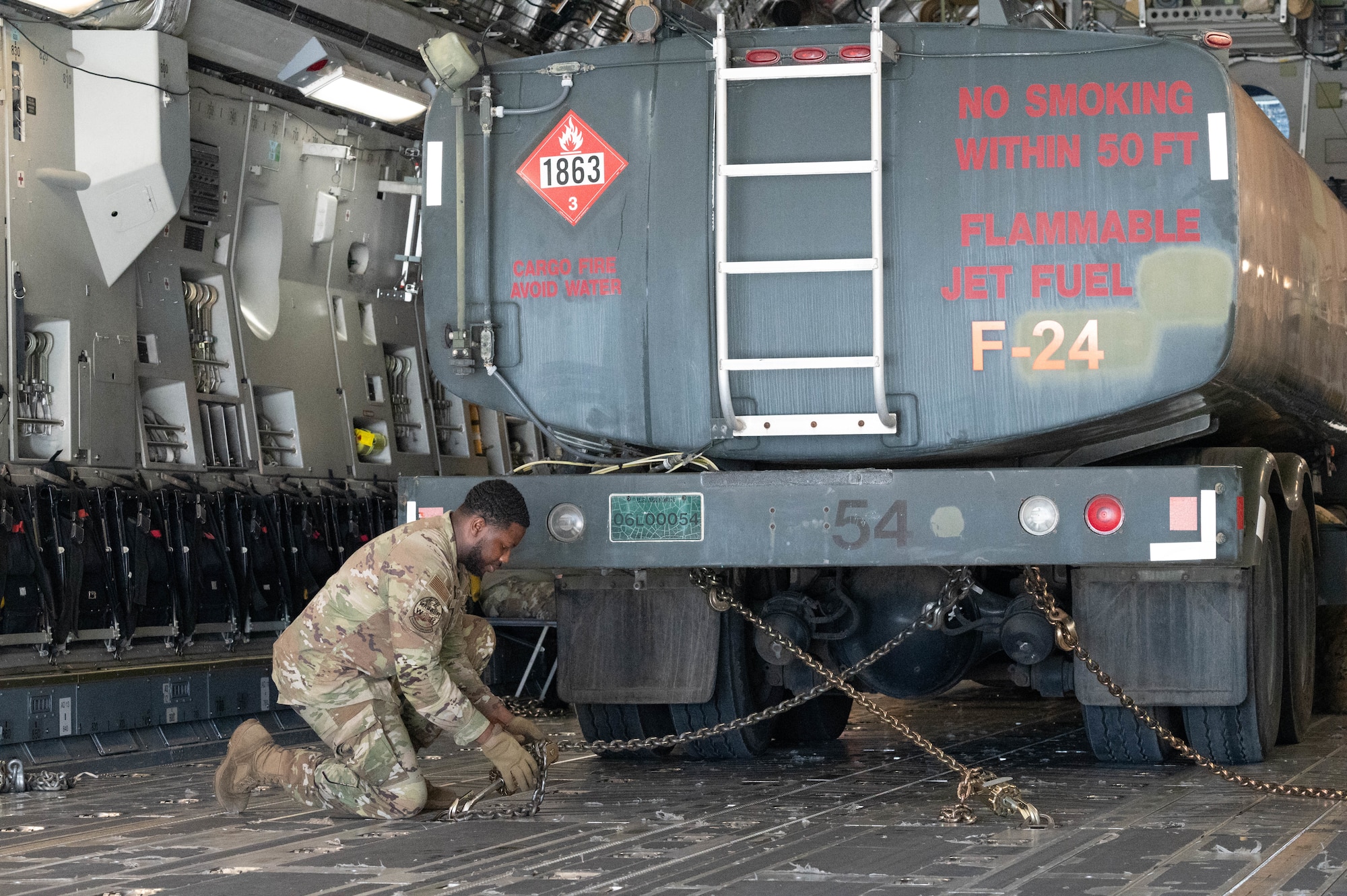 U.S. Air Force Senior Airman David Cook, 7th Airlift Squadron crew chief, loads an R-11 Refueler in a C-17 Globemaster III on Marine Corps Base Hawaii as part of an exercise for Joint Pacific Multinational Readiness Center 25-01 Oct. 9, 2024. The Joint Pacific Multinational Readiness Center (JPMRC) is the Army’s newest Combat Training Center (CTC) and generates readiness in the environments and conditions where our forces are most likely to operate in. JPMRC 25-01 includes training participants from across the U.S. Joint Force, and multinational Allies and partners. (U.S. Air Force photo by Airman 1st Class Aden Brown)