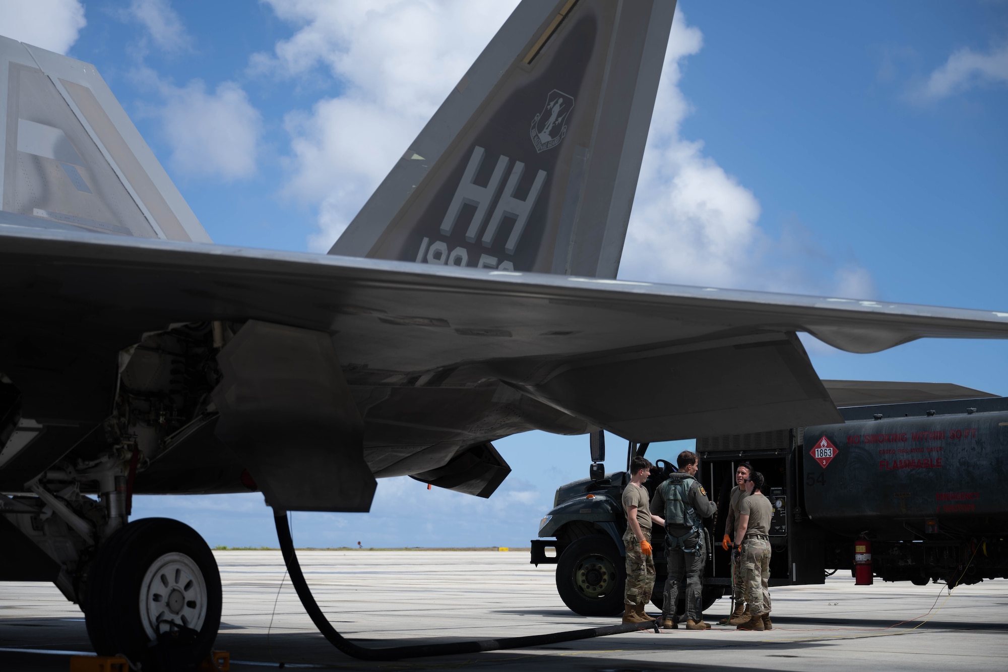 U.S. Air Force Airmen from the 7th Airlift Squadron refuel an F-22 Raptor on the flightline of Marine Corps Base Hawaii during exercise Joint Pacific Multinational Readiness Center 25-01, Oct. 9 2024. The Joint Pacific Multinational Readiness Center (JPMRC) is the Army’s newest Combat Training Center (CTC) and generates readiness in the environments and conditions where our forces are most likely to operate in. JPMRC 25-01 includes training participants from across the U.S. Joint Force, and multinational Allies and partners. (U.S. Air Force photo by Airman 1st Class Aden Brown)