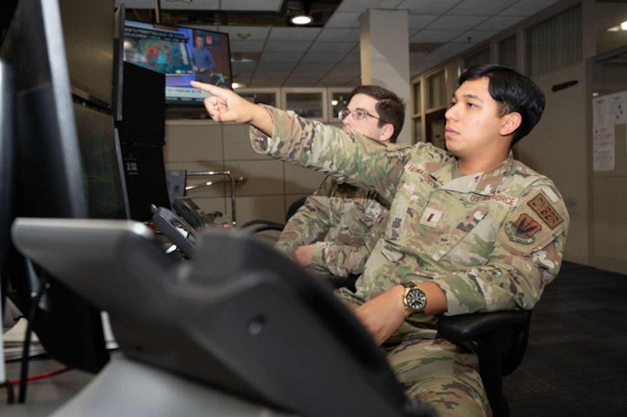 U.S. Air Force 1st Lt. Erasmo Hernandez, 83d Network Operations Squadron crew commander, points at a screen at Joint Base Langley-Eustis, Virginia, Oct. 8, 2024. Hernandez serves as the command authority for cyber security crew operations and ensures mission success by providing command oversight for personnel. (U.S. Air Force photo by Airman Donnell Ramsey)