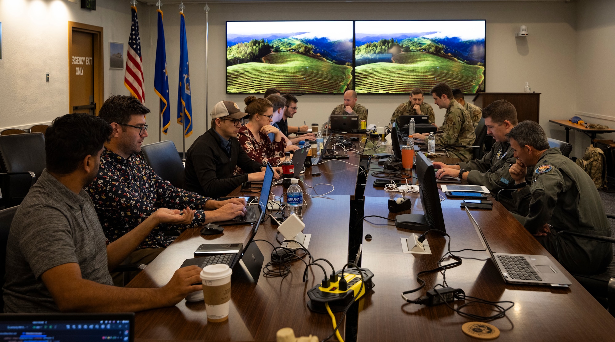Hackathon participants around room coding