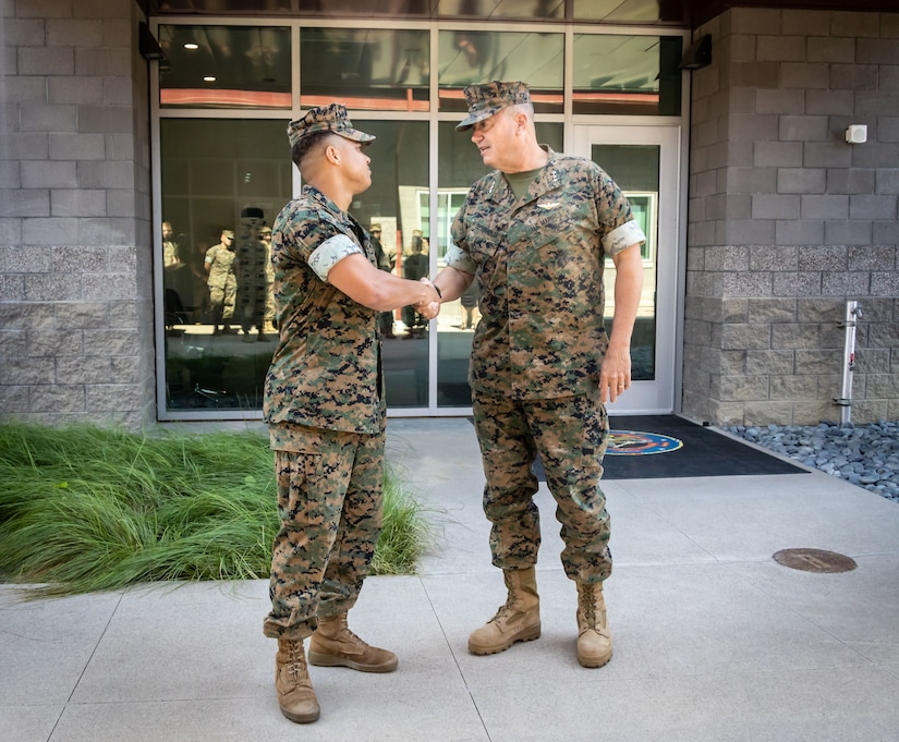 Two Marines shake hands.