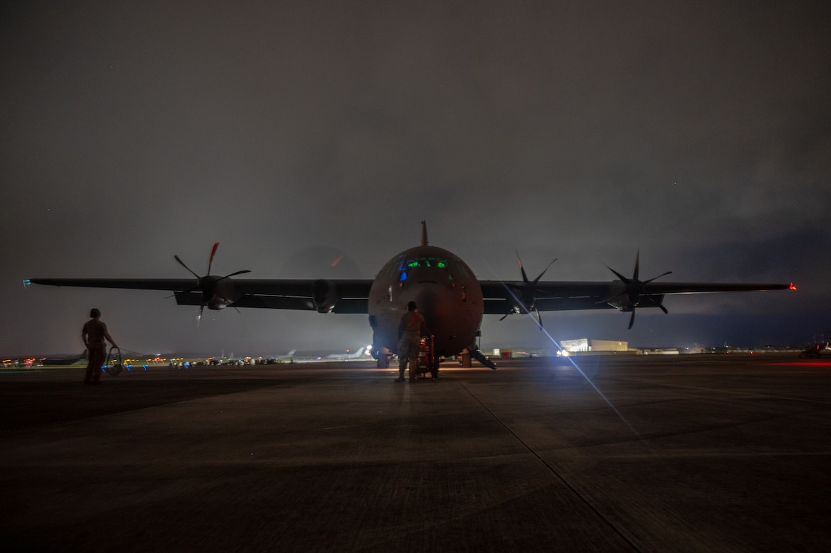 U.S. Air Force loadmasters assigned to the 61st Airlift Squadron watch engine start up of a U.S. Air Force C-130J Super Hercules