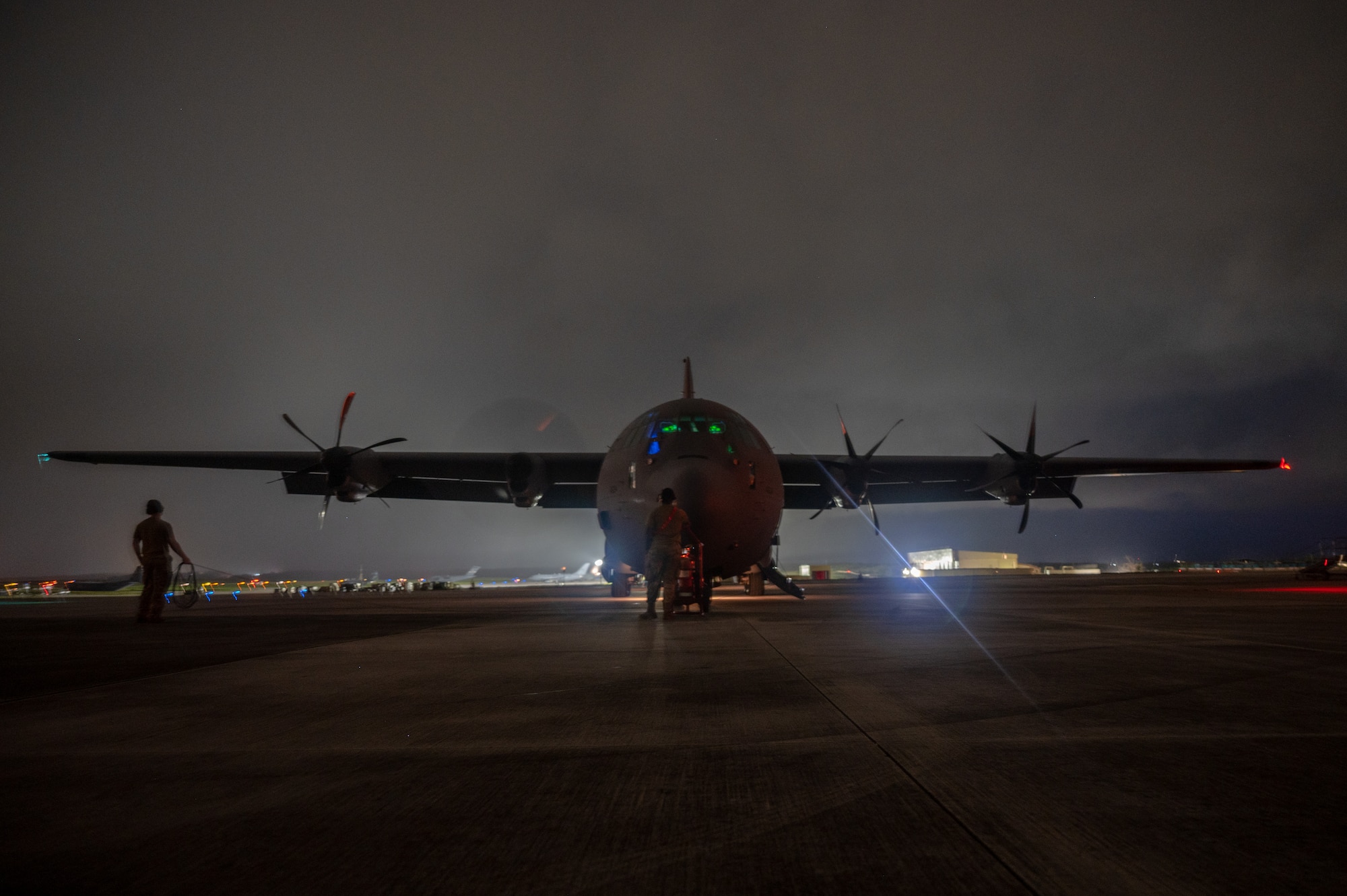 U.S. Air Force loadmasters assigned to the 61st Airlift Squadron watch engine start up of a U.S. Air Force C-130J Super Hercules