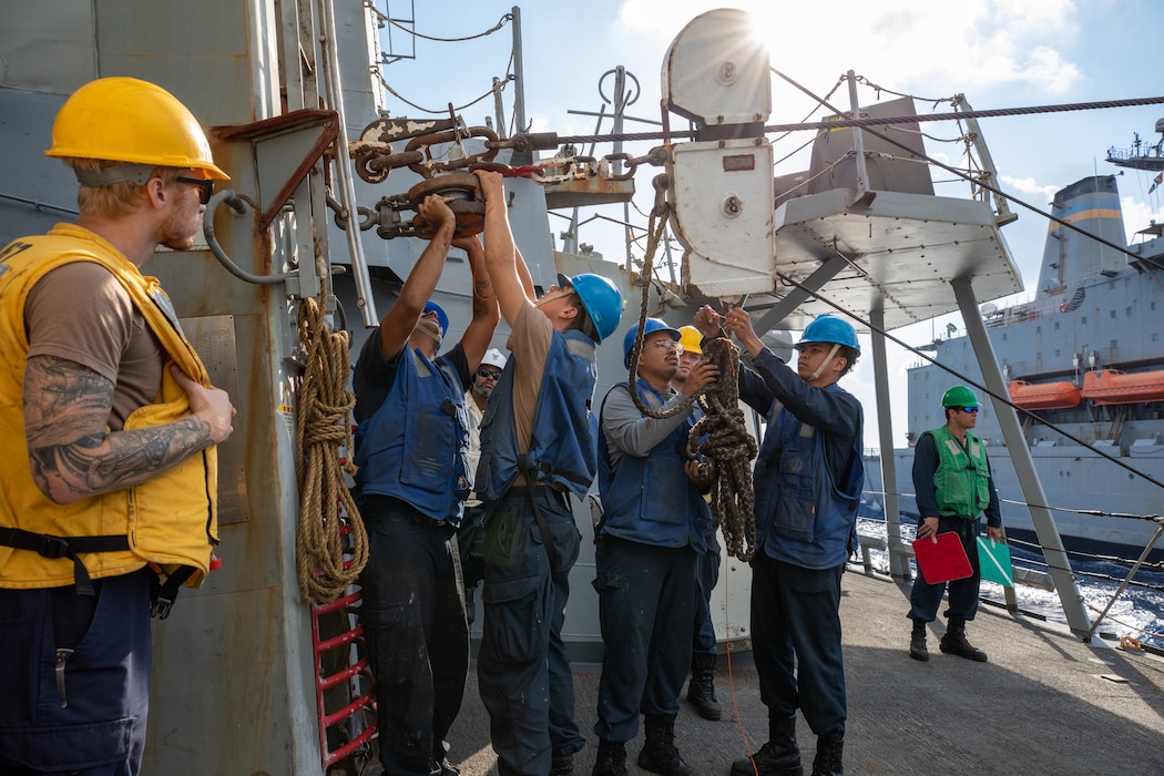 Boatswain's mates prepare the spanning wire during a replenishment aboard the USS Cole (DDG 67) in the U.S. 6th Fleet area of responsibility.