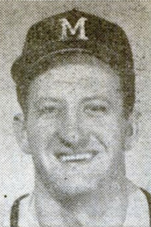 A person in a baseball cap smiles for the camera in a black and white photo.