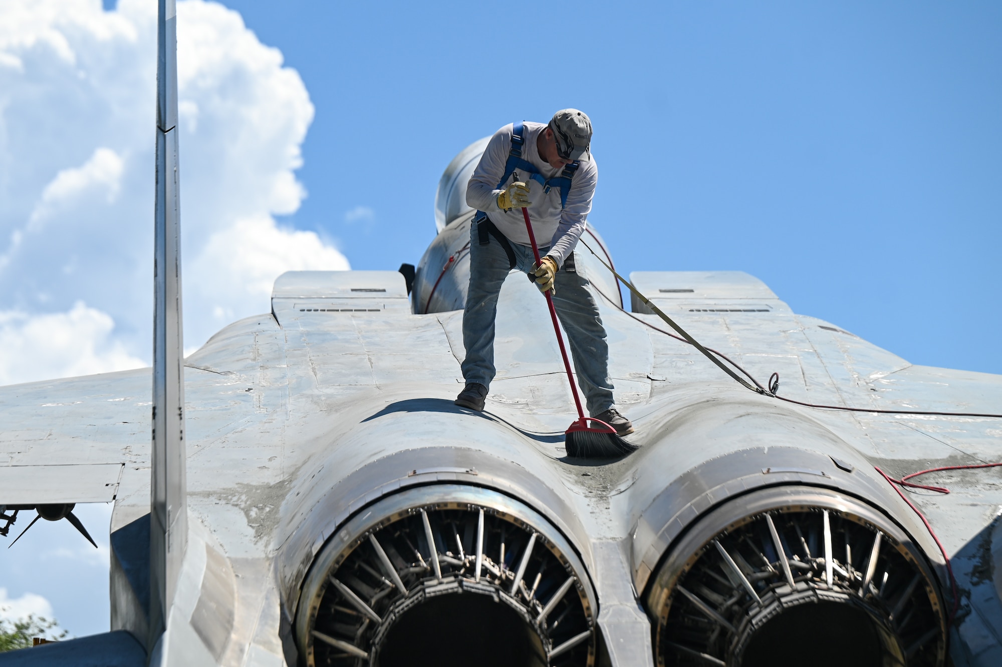 A photo of a man sweeping.