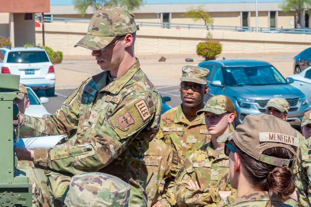 U.S. Air Force Senior Airman Sean Berry, 56th Civil Engineer Squadron electrical systems specialist, teaches Airmen how to operate a portable generator.