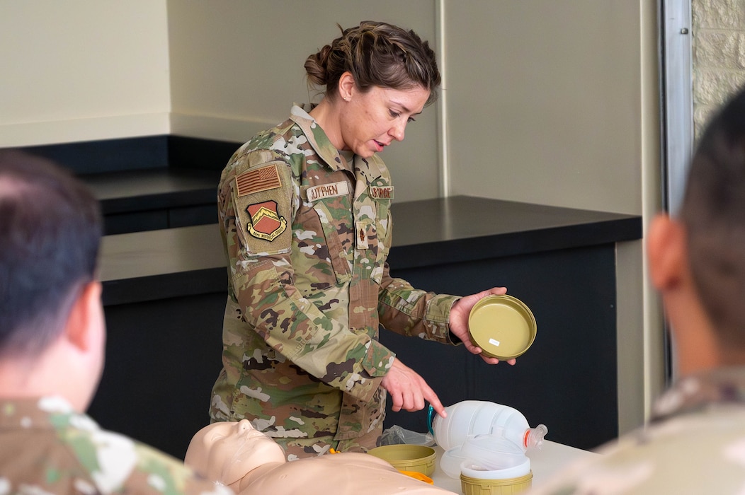 U.S. Air Force Maj. Madelyn Sutphen, 56th Medical Group clinical nurse, instructs Airmen in fundamental CPR techniques and the operation of a manual resuscitation bag.