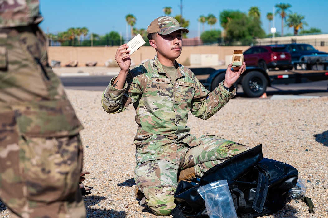 U.S. Air Force Senior Airman Mickey Kimball, 56th Civil Engineer Squadron emergency management specialist, displays essential items for emergency situations.