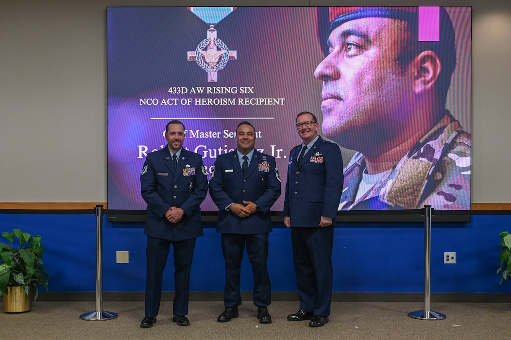 Col. Douglas Jeffrey, right, 433rd Airlift Wing commander, Chief Master Sgt. Robert Gutierrez Jr., center, Air Education and Training Command chief enlisted manager, and Tech. Sgt. Michael Strickler, left, 433rd Airlift Wing Rising Six Council president, pose for a photo at the Pfingston Reception Center after the NCO Induction Ceremony on Joint Base San Antonio-Lackland, Texas on October 5, 2024.