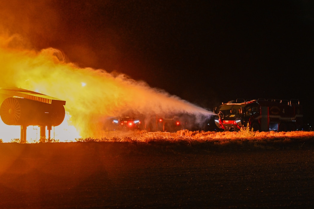 Firefighters from the 97th Civil Engineer Squadron extinguish a fire in a Rosenbauer Panther aircraft rescue and fire fighting vehicle during a live fire exposition for fire prevention week at Altus Air Force Base (AFB), Oklahoma, Oct. 9, 2024. The Rosenbauer Panther has advanced firefighting technology, featuring a powerful water cannon, all-terrain capability, and rapid acceleration, making it ideal for responding to aircraft emergencies swiftly and effectively. (U.S. Air Force photo by Airman 1st Class Jonah Bliss)