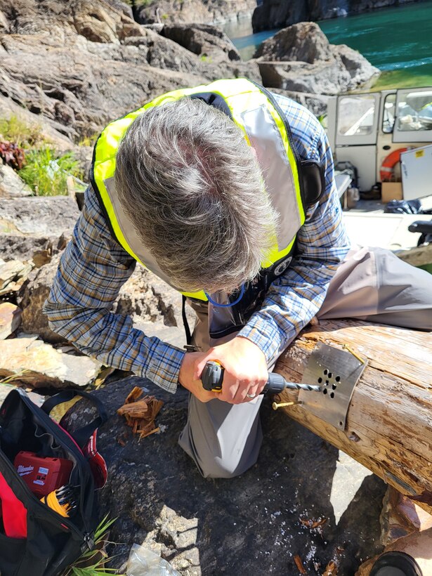 Hydraulic Engineer Zac Corum drills holes into the metal panel of the GPS unit to help increase cellular connection. This is part of the Army Corps’ Engineering with Nature (EWN) program designed to help improve ecosystem function in the Kootenai River downstream of Libby Dam.