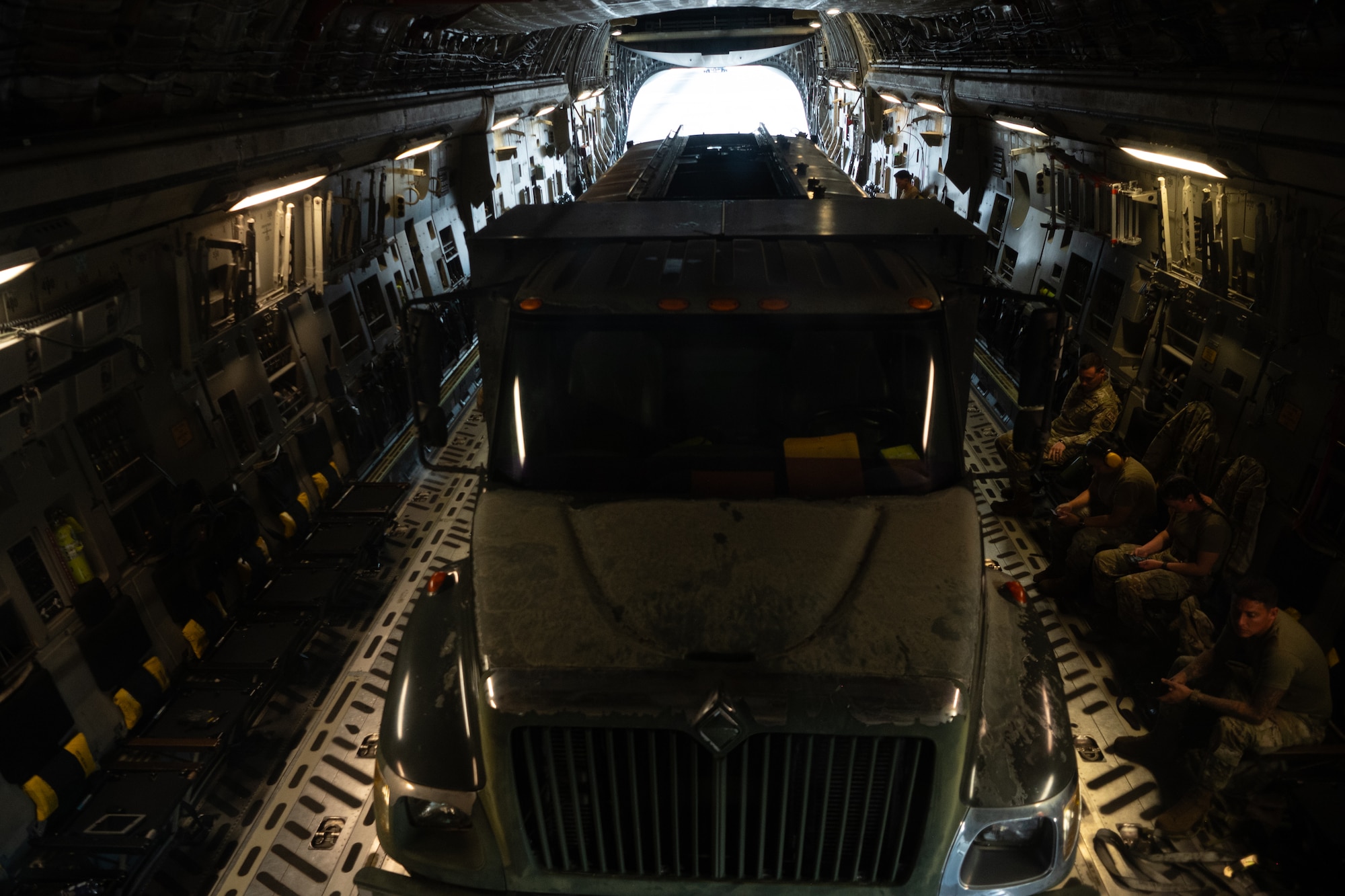 A 62d Logistics Readiness Squadron Petroleum, Oils, and Lubricants truck and passengers are loaded onto a C-17 Globemaster III in preparation for Exercise Rainier War 25A, Oct. 9, 2024.