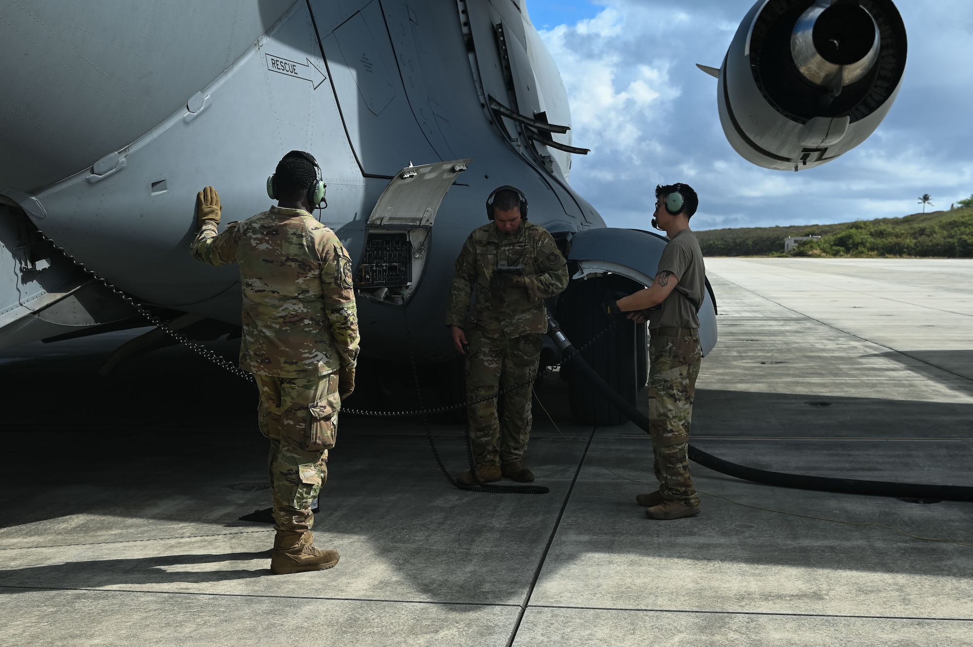 7 Airlift Squadron aircrew members and Petroleum, Oils, and Lubricants Airmen from the 62d Logistics Readiness Squadron perform a defueling operation on a C-17 Globemaster III at Marine Corps Base Hawaii, Oct. 9, 2024.