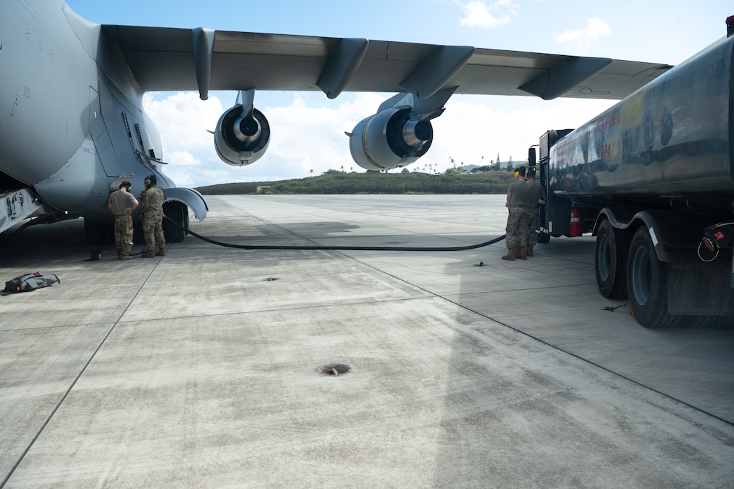 7 Airlift Squadron aircrew members and Petroleum, Oils, and Lubricants Airmen from the 62d Logistics Readiness Squadron perform a defueling operation on a C-17 Globemaster III at Marine Corps Base Hawaii, Oct. 9, 2024.