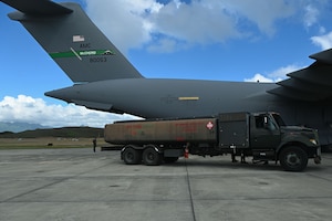 A 62d Logistics Readiness Squadron Petroleum, Oils, and Lubricants (POL) truck sits positioned next to a C-17 Globemaster III during Exercise Rainier War 25A at Marine Corps Base Hawaii, Oct. 9, 2024.