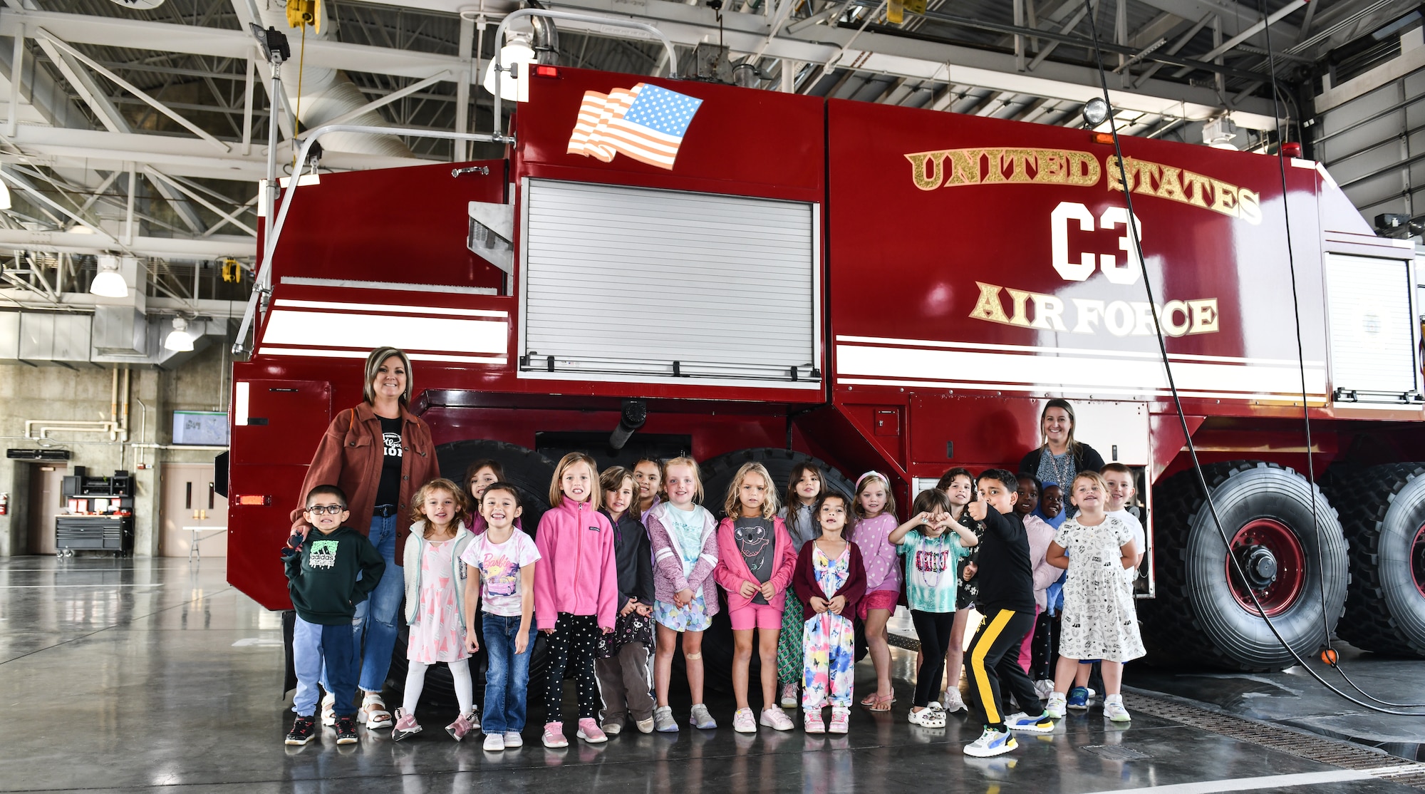 Carrie Weaver's kindergarten class poses in front of a fire engine during a tour of Offutt Air Force Base's fire department for National Fire Prevention Week on Oct. 10, 2024. The theme of this year's National Fire Prevention Week was "Smoke Alarms: Make Them Work for You." (U.S. Air Force photo by Chad Watkins)