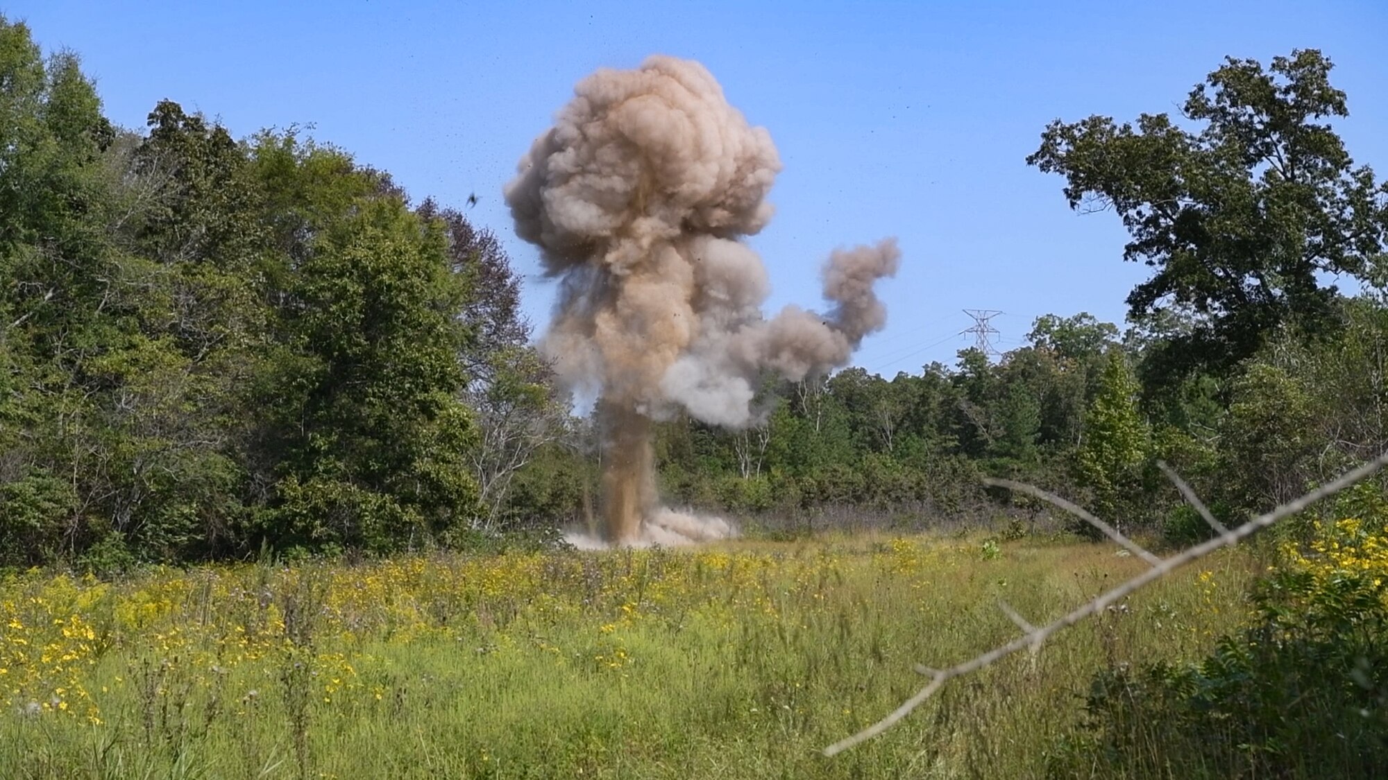 Leftover explosive test materials and items containing residue from a recent test are destroyed during an explosives disposal Sept. 10, 2024, at Arnold AFB, Tenn., headquarters of Arnold Engineering Development Complex. The 96th Civil Engineer Squadron Explosive Ordnance Disposal Flight from Eglin Air Force Base, Florida, helped plan both the testing and the disposal of the remaining explosives. These materials were detonated in a remote area of Arnold AFB using a charge of explosives. (U.S. Air Force still image pulled from video shot by Keith Thornburgh)