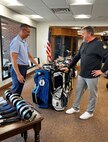 two people look at golf bags
