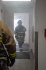 Firefighters from the 152nd Civil Engineer Squadron enter a building that is notionally on fire during a continuity of operations exercise at the Nevada Air National Guard Base in Reno, Nev., Sept. 25, 2024. The exercise evaluated the base’s ability to operate in a degraded communications environment after a natural disaster, in this case, a simulated earthquake.