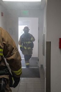 Firefighters from the 152nd Civil Engineer Squadron enter a building that is notionally on fire during a continuity of operations exercise at the Nevada Air National Guard Base in Reno, Nev., Sept. 25, 2024. The exercise evaluated the base’s ability to operate in a degraded communications environment after a natural disaster, in this case, a simulated earthquake.