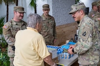 U.S. Soldiers from the Florida and South Carolina National Guard distribute water, meals and sanitation kits to residents of St. Lucie County, Florida, who were impacted by tornadoes caused by Hurricane Milton, Oct. 11, 2024. Soldiers and Airmen will staff point of distribution centers across disaster-affected areas of the state as relief efforts continue.