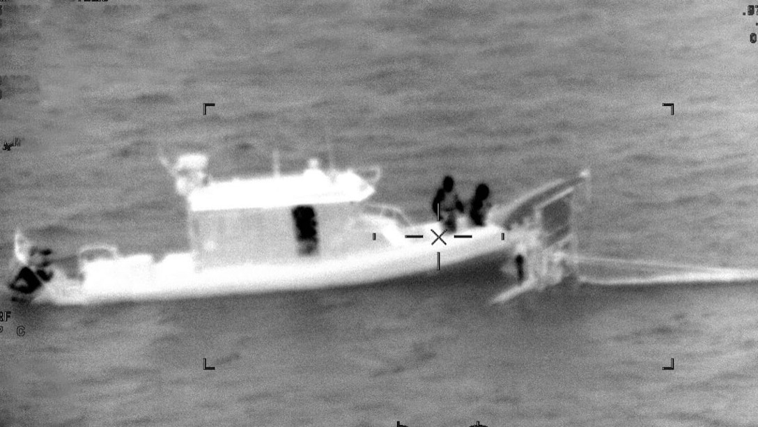 A Coast Guard Station Miami Beach boat crew rescues two people from the water after their catamaran capsized a mile south of Cape Florida, Oct. 11, 2024. The two people were taken to shore with no medical concerns. (U.S. Coast Guard photo)