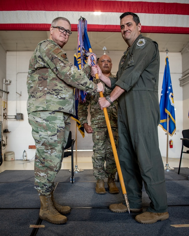 Col. Matthew Quenichet (right), incoming commander for the 123rd Airlift Wing, accepts the wing guidon from Brig. Gen. David Mounkes, the Kentucky National Guard’s assistant adjutant general for Air, as Quenichet assumes command of the wing during a change-of-command ceremony at the Kentucky Air National Guard Base in Louisville, Ky., Oct. 11, 2024. Quenichet replaces Col. Bruce Bancroft, who has led the unit since 2021 and will be moving into a new leadership role at Joint Force Headquarters—Kentucky. (U.S. Air National Guard photo by Master Sgt. Joshua Horton)