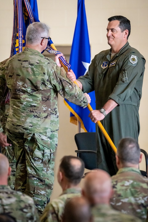 Col. Matthew Quenichet, right, takes the guidon of the 123rd Airlift Wing from Brig. Gen. David Mounkes, the Kentucky National Guard’s assistant adjutant general for Air, as Quenichet assumes command of the wing during a formal ceremony at the Kentucky Air National Guard Base in Louisville, Ky., Oct. 11, 2024. Quenichet, a career navigator and longtime wing member, replaces Col. Bruce Bancroft, who has led the highly decorated unit since 2021 and will be moving to a new leadership role at Joint Force Headquarters–Kentucky. (U.S. Air National Guard photo by Dale Greer)