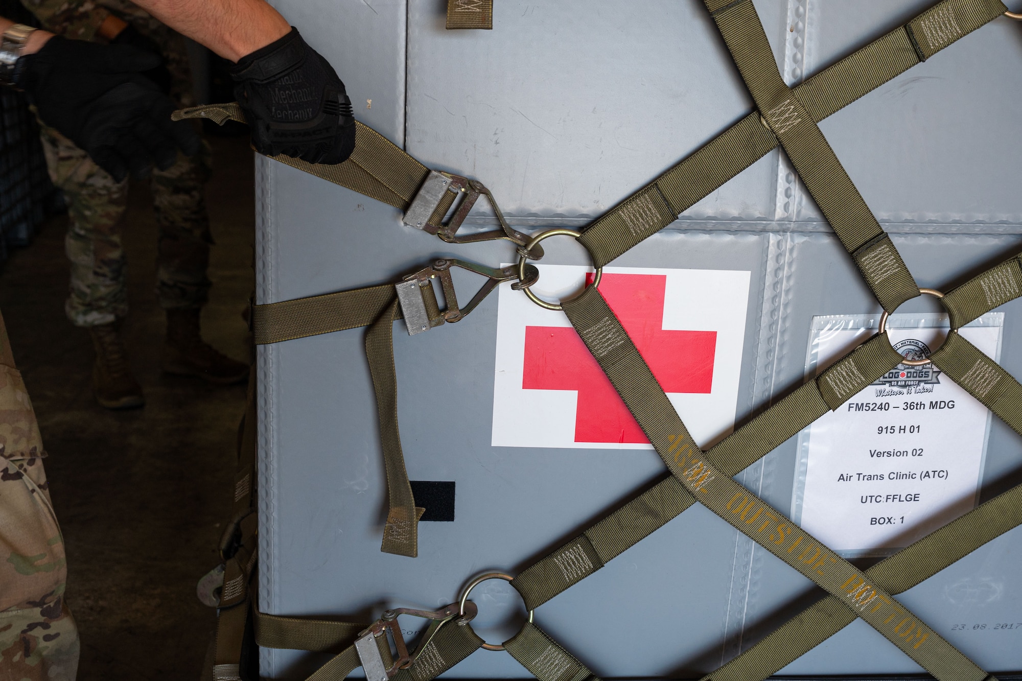 U.S. Air Force Tech. Sgt. Robert Bickelhaupt, 36th Medical Group healthcare technology management section chief, pulls a netting strap to secure air trans clinics Slingstone 24-4 at Andersen Air Force Base, Guam, Oct. 15, 2024. Slingstone 24-4 is a training exercise that demonstrates Team Andersen’s credibility to address a complex and uncertain security environment. (U.S. Air Force photo by Senior Airman Jasmine M. Barnes)