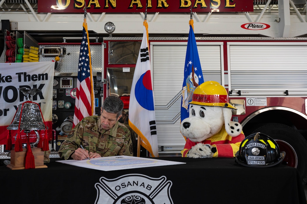 U.S. Air Force Col. William McKibban, 51st Fighter Wing commander, signs a Fire Prevention Week proclamation at Osan Air Base, Republic of Korea, Oct. 7, 2024. The fire proclamation signing is an annual event that highlights the commander’s dedication to promoting fire safety awareness across the installation. (U.S. Air Force photo by Staff Sgt. Christopher Tam)