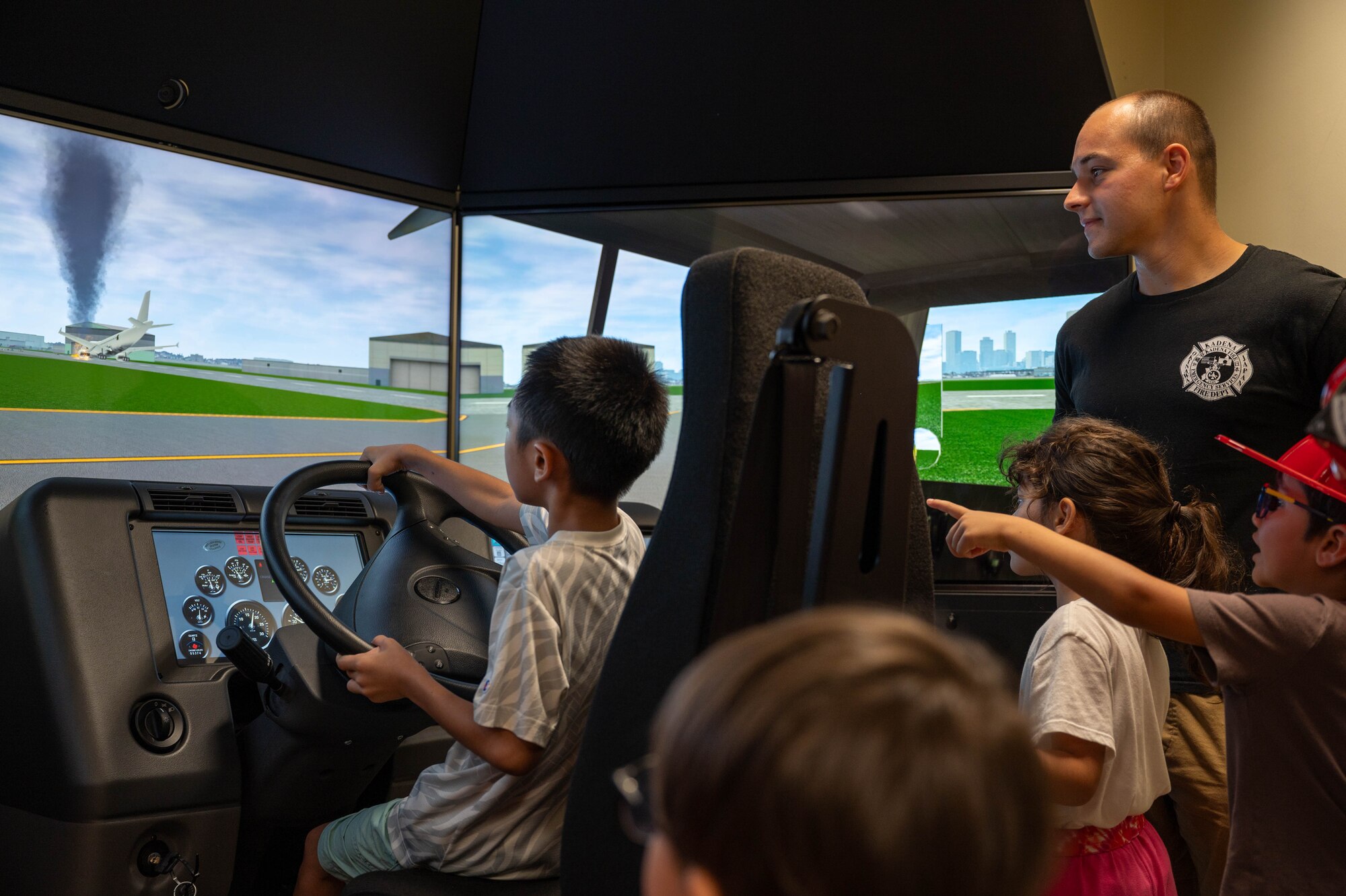 Participants trying out a VR fire truck simulator