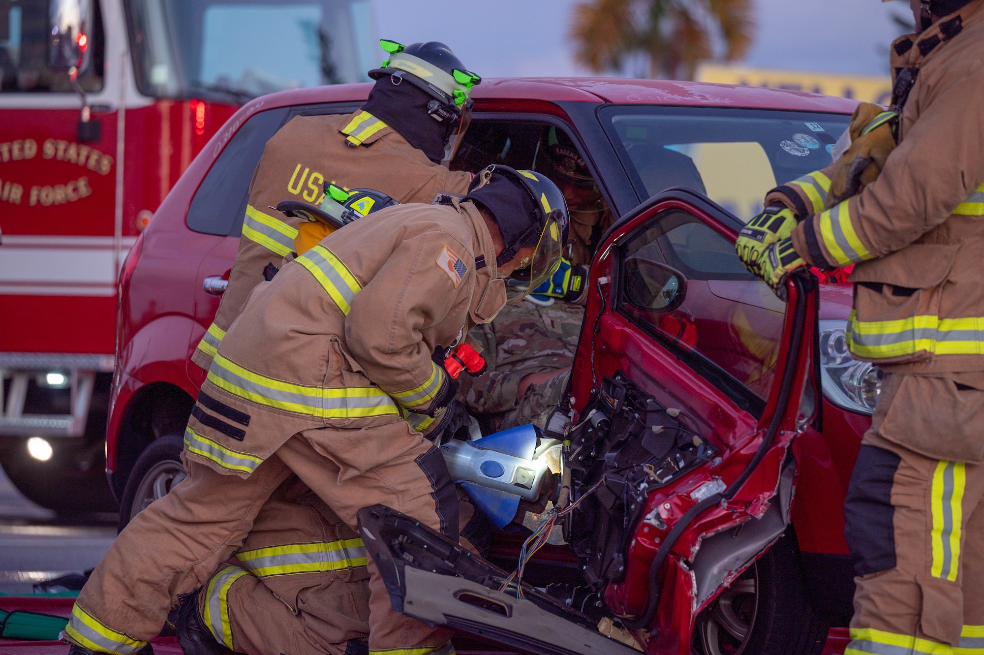 Firefighters conducting a vehicle extrication