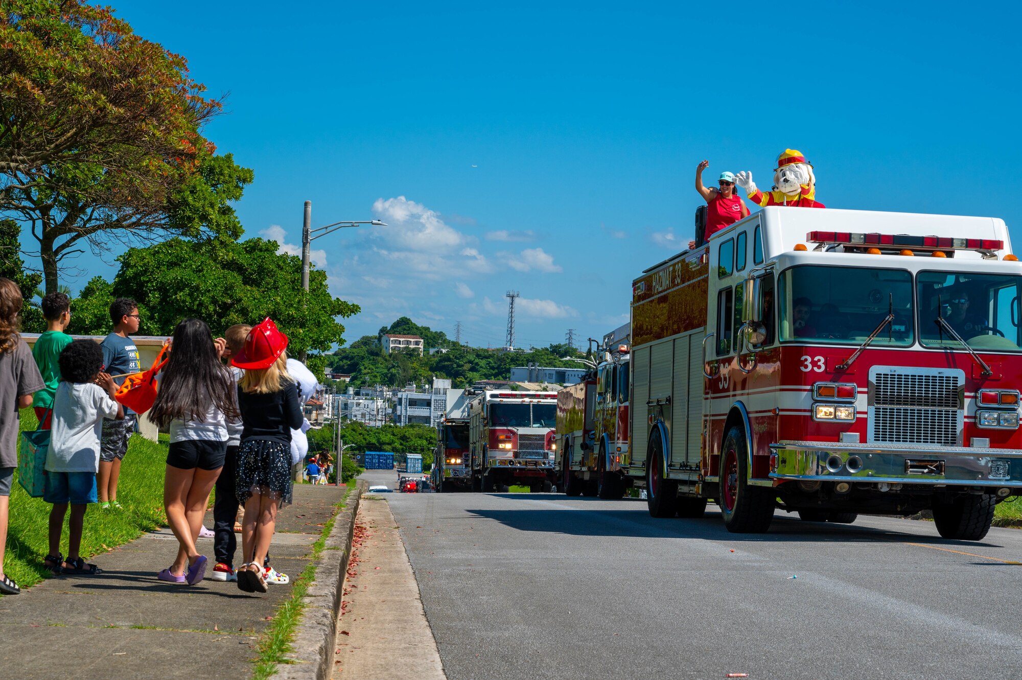 Sparky the Dog on a fire truck throwing candy