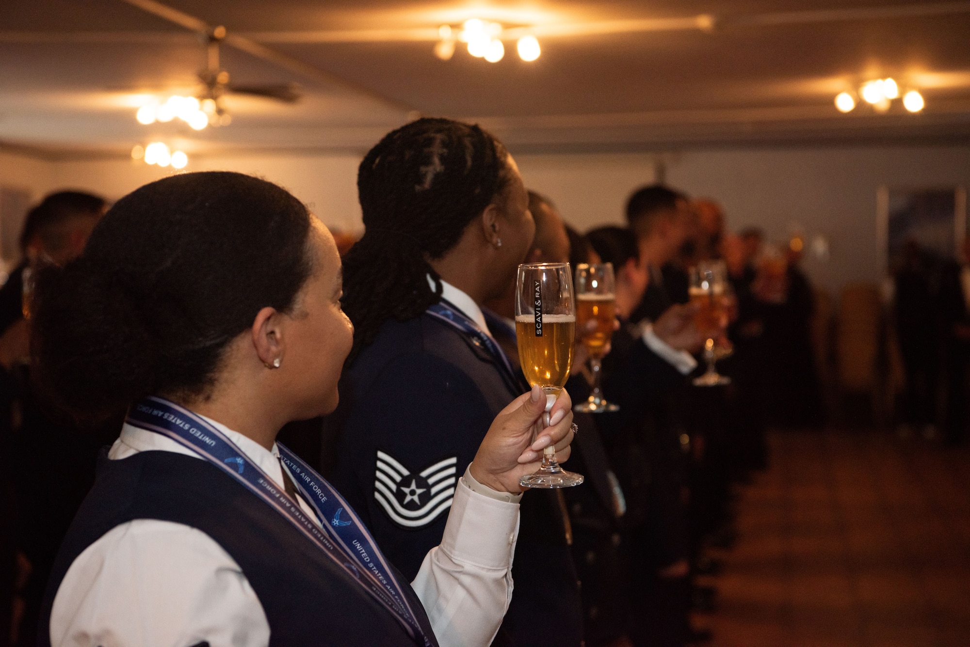 The newest senior noncommissioned officers of the U.S. Air Force and U.S. Space Force raises their glasses in a celebratory toast.