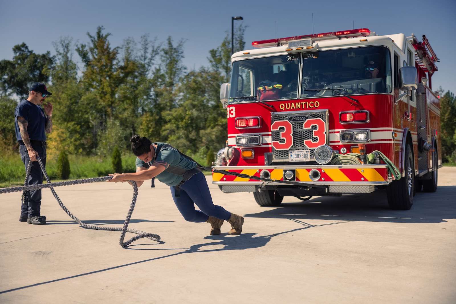 U.S. Marine Corps Capt. Jacqueline Sapitro, a student at the Expeditionary Warfare School, pulls a firetruck during her training for a strongman competition at Fire Station 533 on Marine Corps Base Quantico, Virginia, Oct. 5, 2024. Sapitro’s training consisted of the pulling of a fire station truck and ambulance as well as overhead pressing two three-inch water hoses. (U.S. Marine Corps photo by Cpl. Darien Wright)