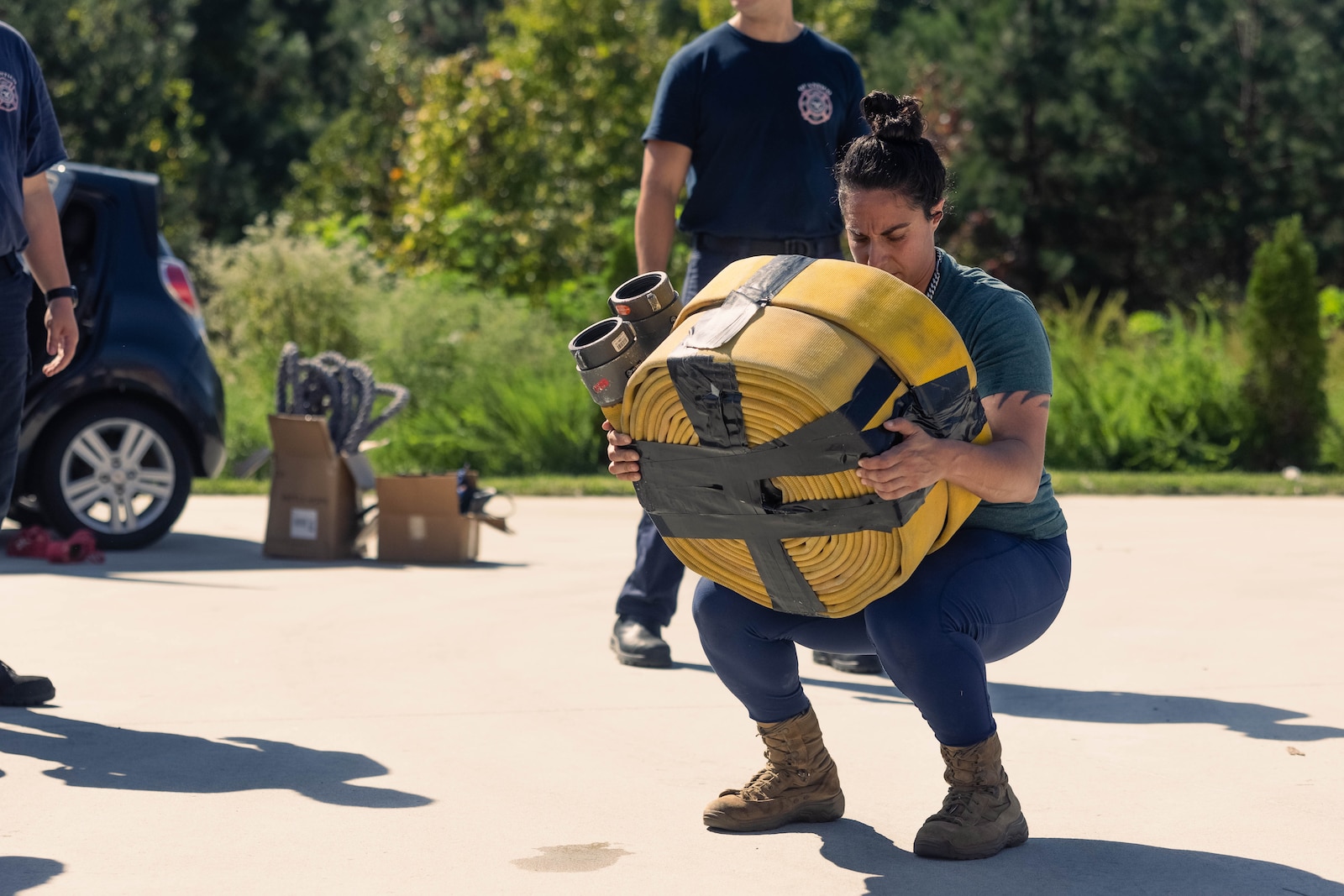 U.S. Marine Corps Capt. Jacqueline Sapitro, a student at the Expeditionary Warfare School, lifts two fire hoses during her training for a strongman competition at Fire Station 533 on Marine Corps Base Quantico, Virginia, Oct. 5, 2024. Sapitro’s training consisted of the pulling of a fire station truck and ambulance as well as overhead pressing two three-inch water hoses. (U.S. Marine Corps photo by Cpl. Darien Wright)