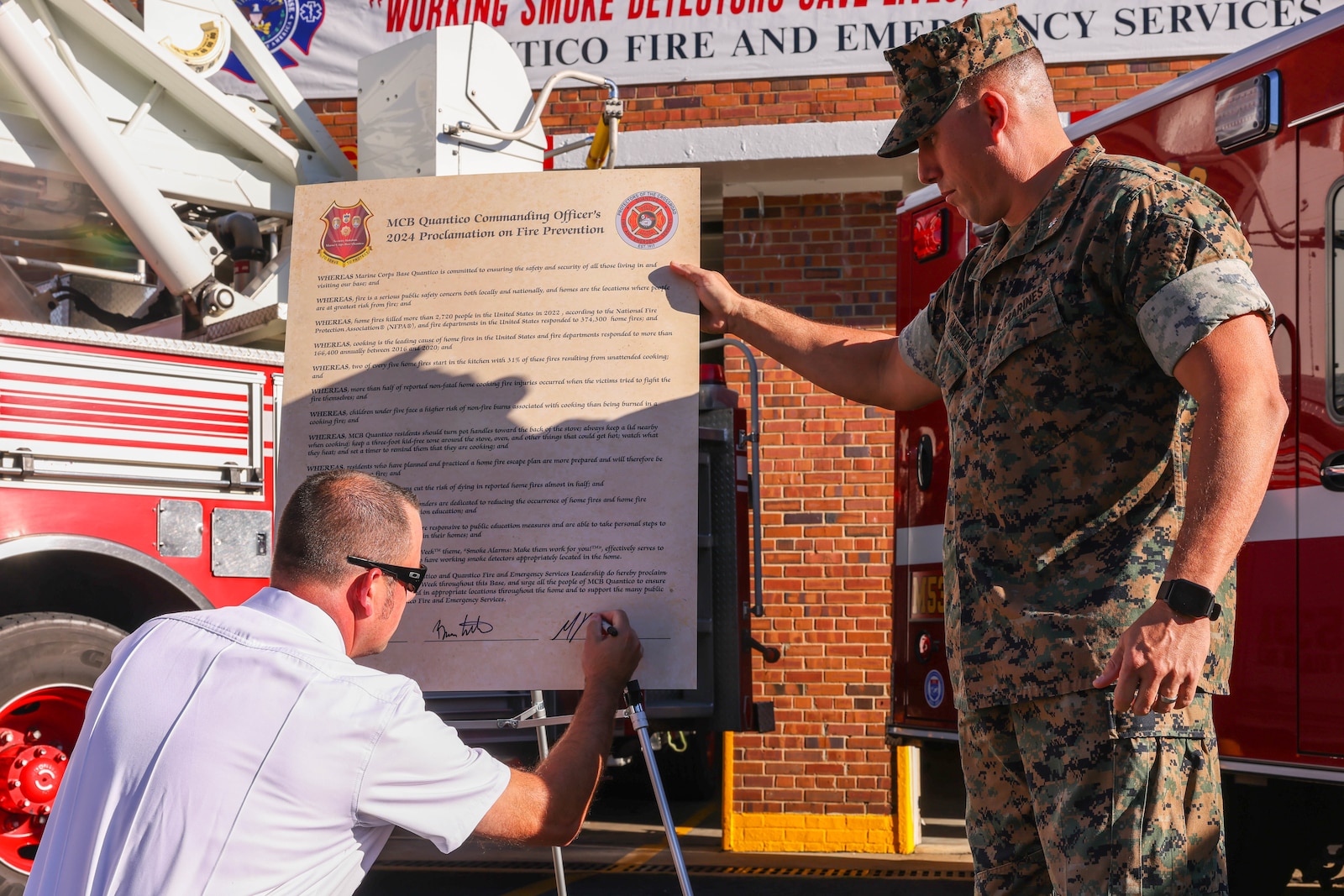 Mike Passera, captain of the Quantico Fire and Emergency Services, signs the Fire Prevention Proclamation on Marine Corps Base Quantico, Virginia, Oct. 8, 2024. Fire Prevention Week highlights the importance of fire safety awareness to educate families and students on MCBQ and the surrounding communities. (U.S. Marine Corps photo by Lance Cpl. David Brandes)