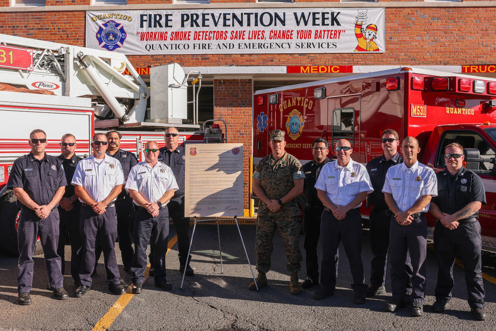 U.S. Marine Corps Lt. Col. Gerard W. VanderWaal, commanding officer of Security Battalion, and members of the Quantico Fire Department at Firehouse 531 pose for a group photo on Marine Corps Base Quantico, Virginia, Oct. 8, 2024. Fire Prevention Week highlights the importance of fire safety awareness to educate families and students on MCBQ and the surrounding communities. (U.S. Marine Corps photo by Lance Cpl. David Brandes)