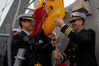 Cmdr. Scott Burrill, the commanding officer of the Arleigh-Burke class guided-missile destroyer USS Oscar Austin (DDG 79), raises a Spanish flag with Spanish Armada Capt. Ernesto Guesos, Commander, 41st Frigate Squadron, during the ship's homeport shift to Naval Station (NAVSTA) Rota, Spain, from NAVSTA Norfolk, Va., Oct. 15, 2024.