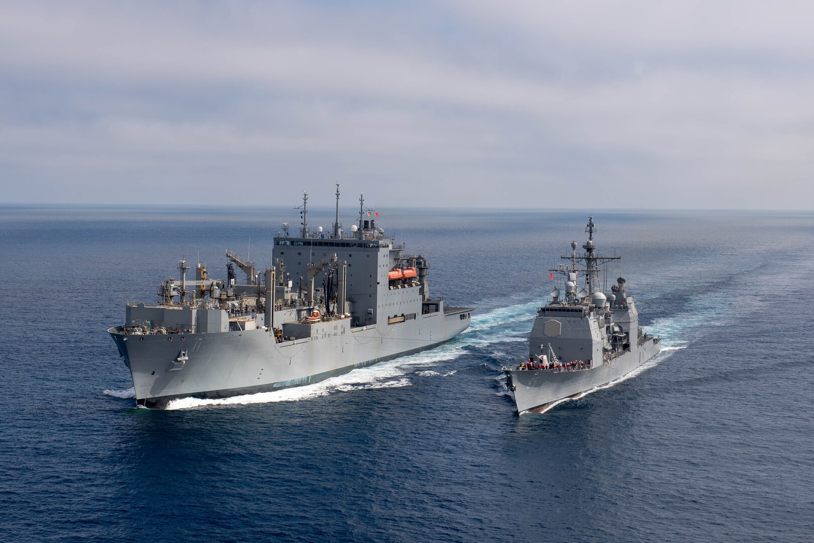 USS Chosin (CG 65) and USNS Washington Chambers (T-AKE 11) during an at-sea demonstration of the Transferrable Reload At-sea Method (TRAM) while underway in the Pacific Ocean.