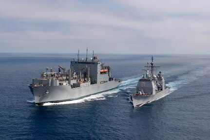 USS Chosin (CG 65) and USNS Washington Chambers (T-AKE 11) during an at-sea demonstration of the Transferrable Reload At-sea Method (TRAM) while underway in the Pacific Ocean.