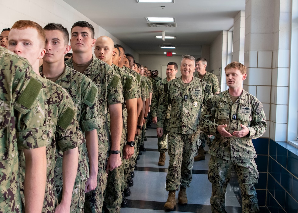 241002-N-GU344-1063 GREAT LAKES, Il. (Oct. 2, 2024) -- Commander, Navy Recruiting Command Rear Adm. James P. Waters, center, greets recruits standing in line for chow at Recruit Training Command, Oct. 2, 2024. Boot camp is approximately 10 weeks long and all enlistees into the U.S. Navy begin their careers at the command. More than 40,000 recruits train annually at the Navy's only boot camp. (U.S. Navy photo by Mass Communication Specialist 1st Class John Suits)