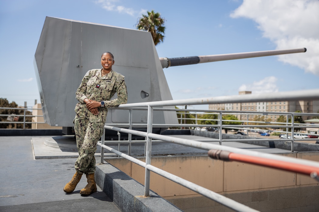 Gunner's Mate 1st Class DeAngela Smith, assigned to Surface Combat Systems Training Command (SCSTC), poses for a portrait at the The Gun Line onboard Naval Base San Diego on Sept. 20, 2024. Smith is an instructor for the Mk 45 MOD 2 Gun Weapons System at SCSTC, preparing sailors for their operational roles within the U.S. Navy. (U.S. Navy photo by Austen McClain)